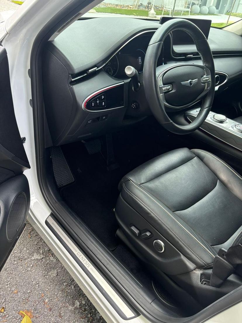 The same Genesis footwell with a clean carpet and leather after the interior detail